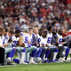 Members of the Dallas Cowboys link arms and kneel during the national anthem before the start of the NFL game against the Arizona Cardinals at the University of Phoenix Stadium on Sept. 25, 2017, in Glendale, Ariz. (Christian Petersen/Getty Images)